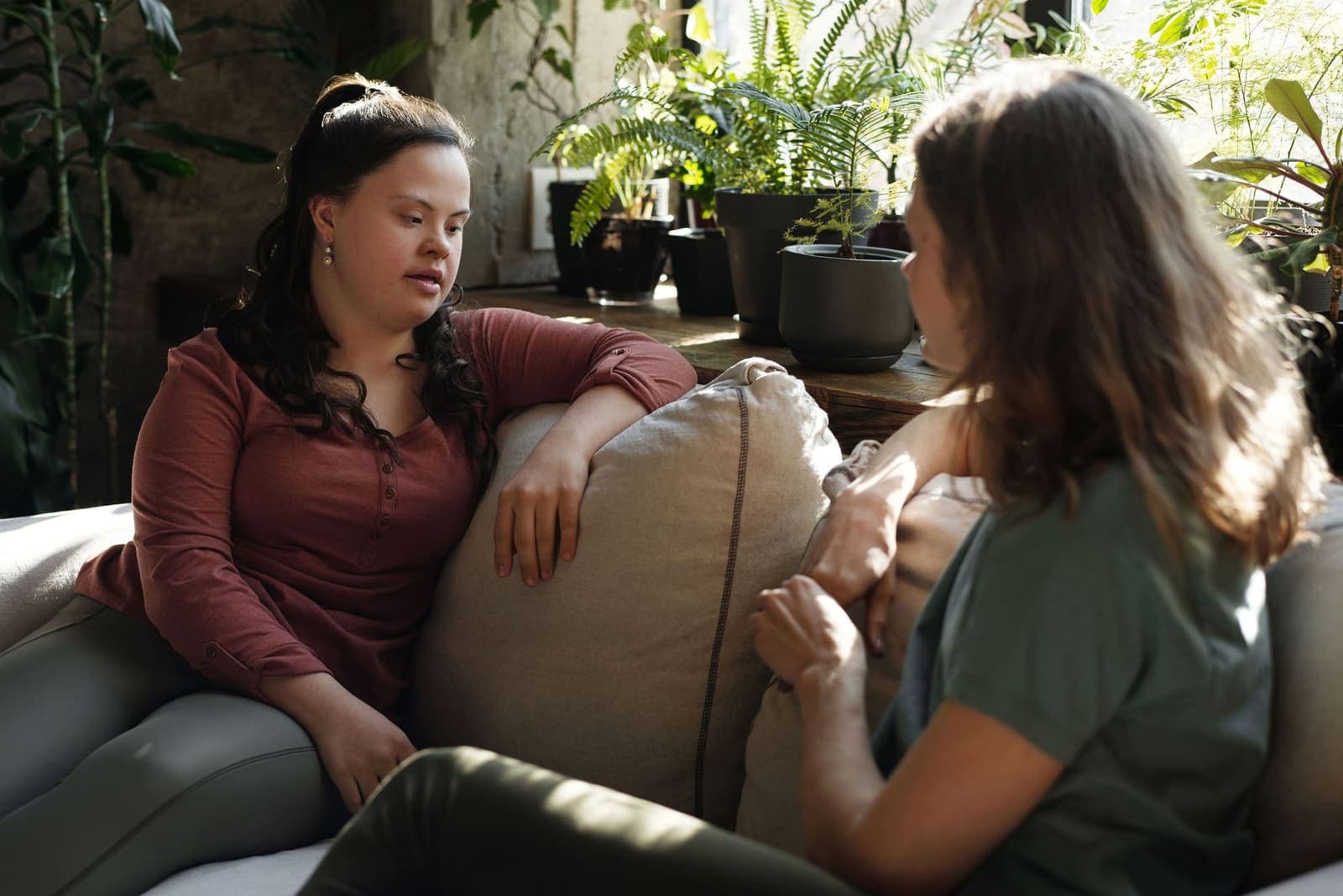 Support worker and participant having a warm conversation at home